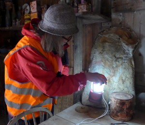 Carol looking at an exhibit inside the hut